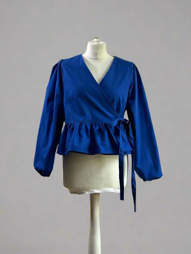 Blue blouse on a mannequin against a gray background