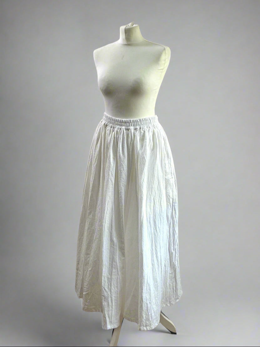 White petticoat on a mannequin against a gray background